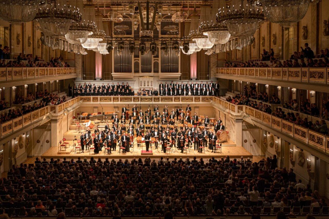 Grand concert hall with orchestra and audience